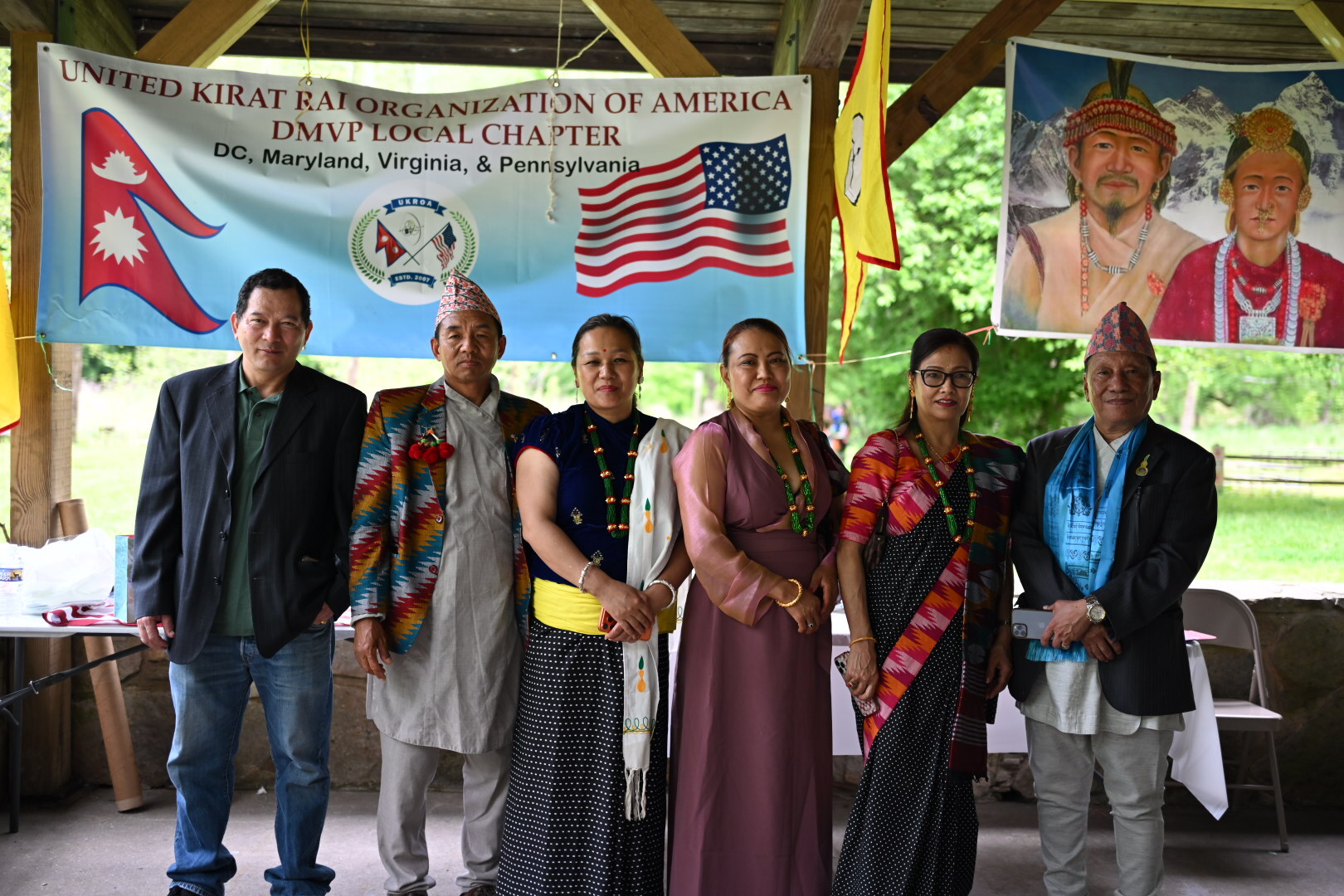 Community members posing in front of the DMVP banner