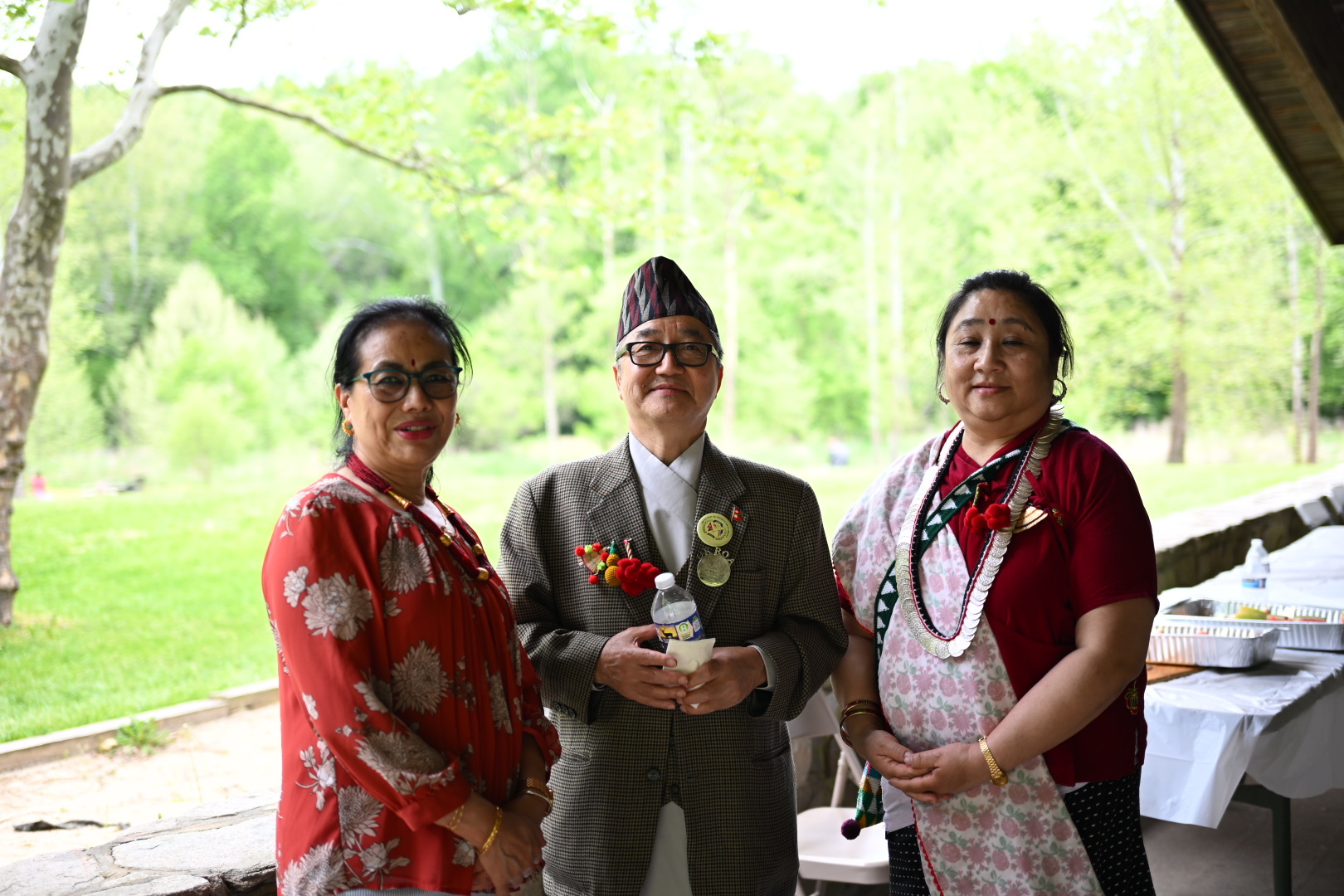 Three community members in traditional attire